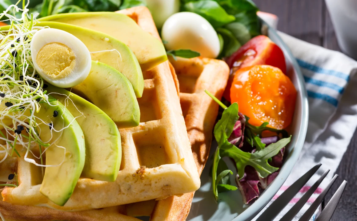 Savory Belgian Waffle with Avocado, Eggs, Microgreens & Tomatoes